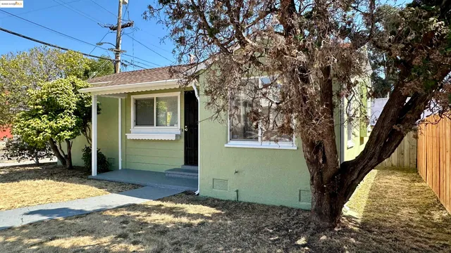 a view of a house with a large tree