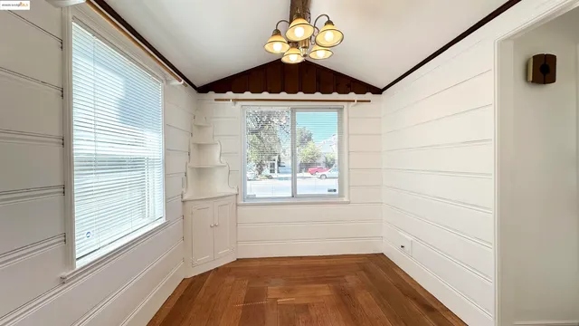 a view of a room with a window and a ceiling fan