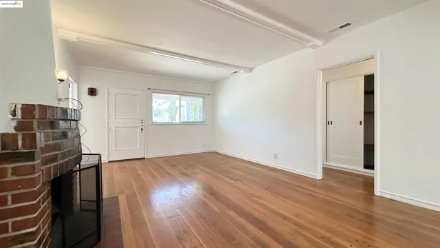 wooden floor in an empty room with a window