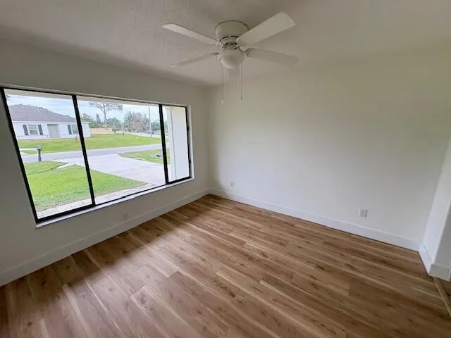 wooden floor in an empty room with a window