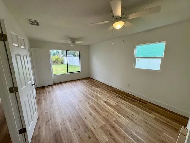 wooden floor in an empty room with a window