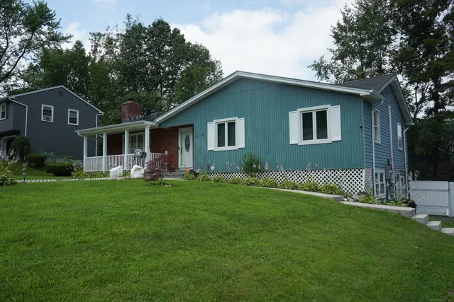 a front view of house with yard and green space