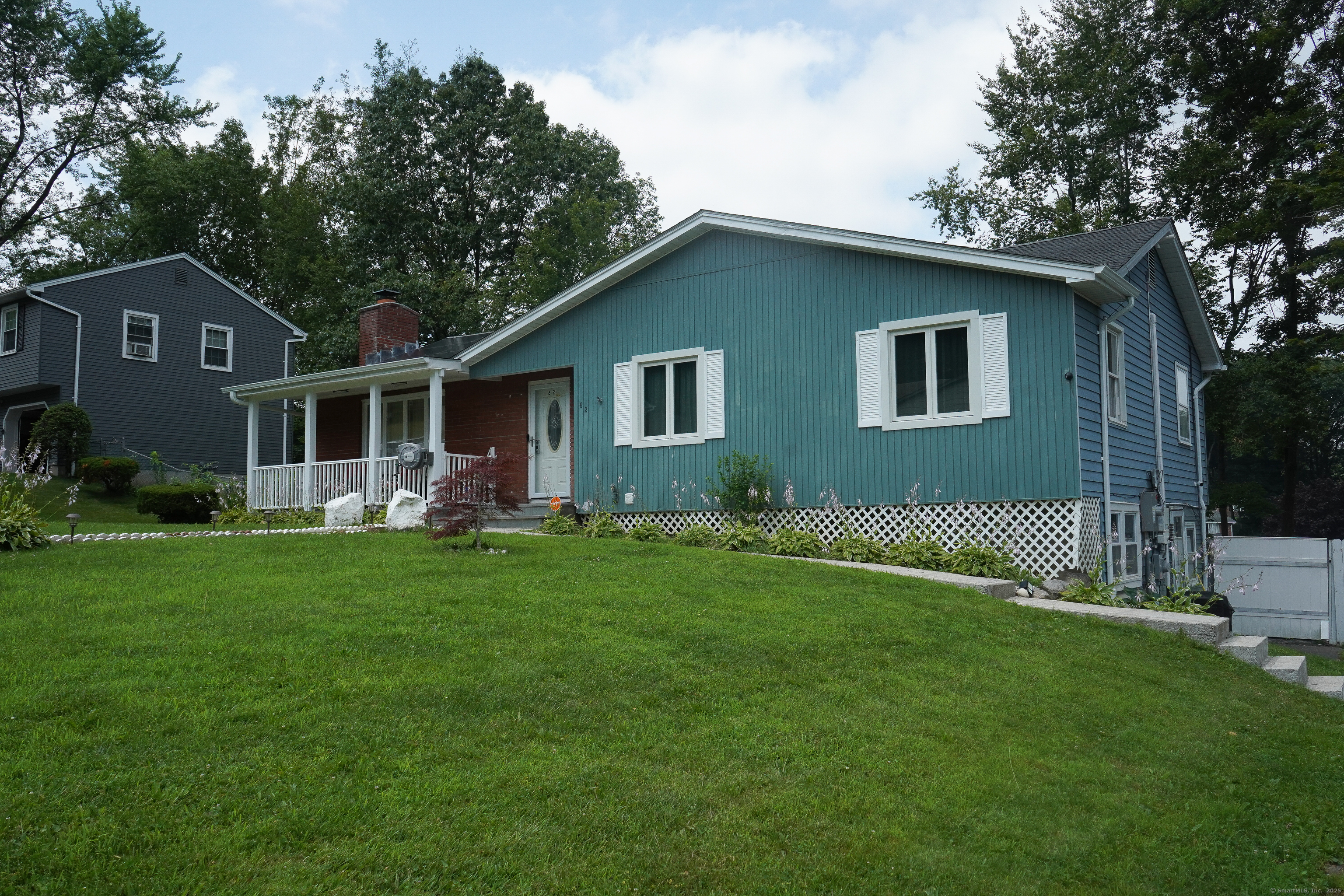 a front view of house with yard and green space