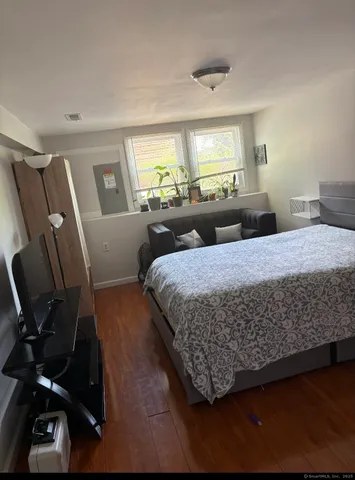 a bedroom with bed and window