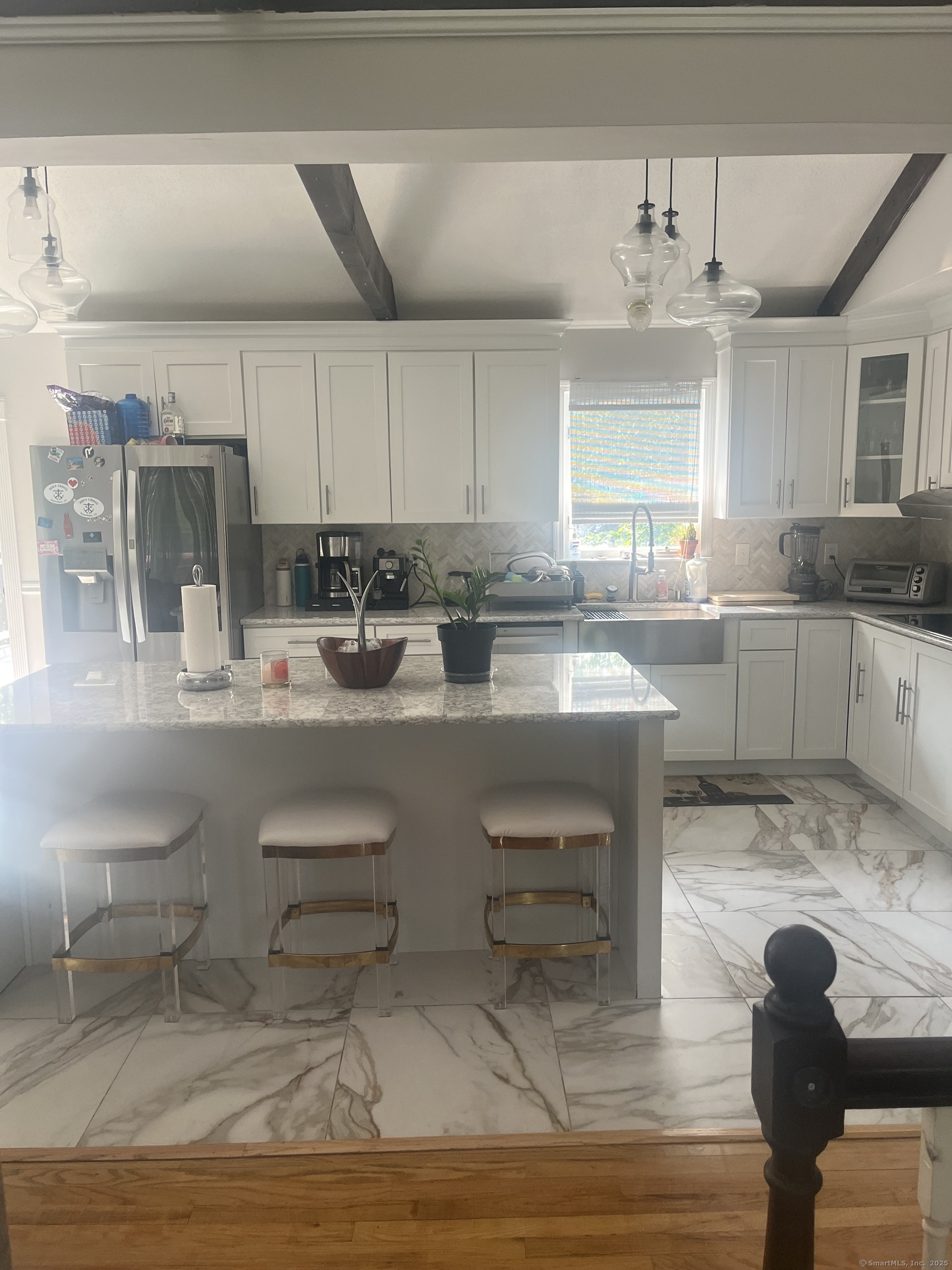 62 Haddad Road Waterbury, CT 06708 - Photo 5 of 15 a kitchen with kitchen island granite countertop a table chairs sink and cabinets