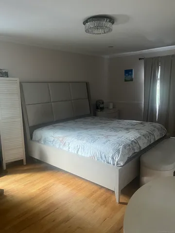a bedroom with a bed and a night stand