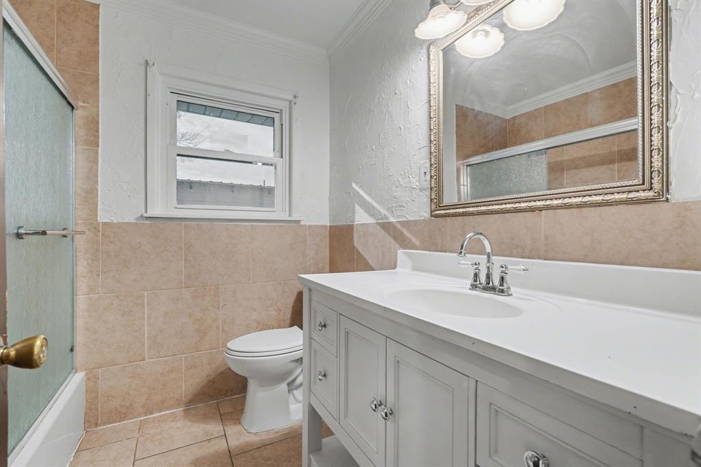 1714 East Union Bower Road Irving, TX 75061 - Photo 26 of 32 a bathroom with a sink a toilet and a mirror
