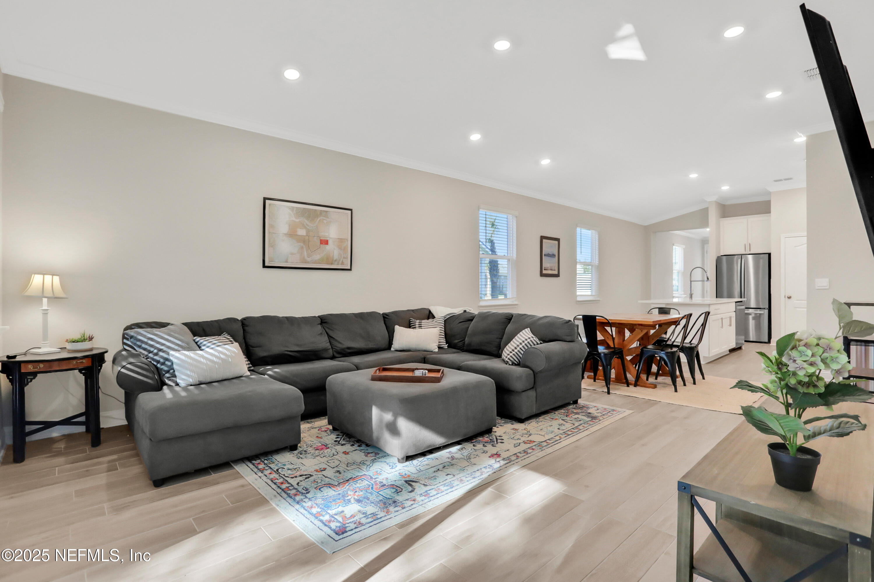 404 Thistleton Way Street St. Augustine, FL 32092 - Photo 11 of 36 a living room with furniture potted plant and kitchen view