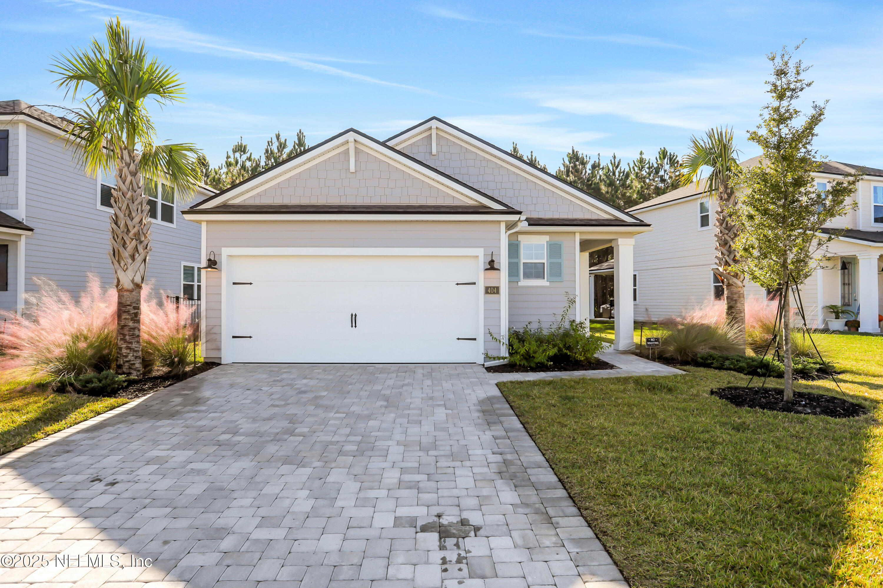 404 Thistleton Way Street St. Augustine, FL 32092 - Photo 30 of 36 a view of a white house next to a yard with potted plants