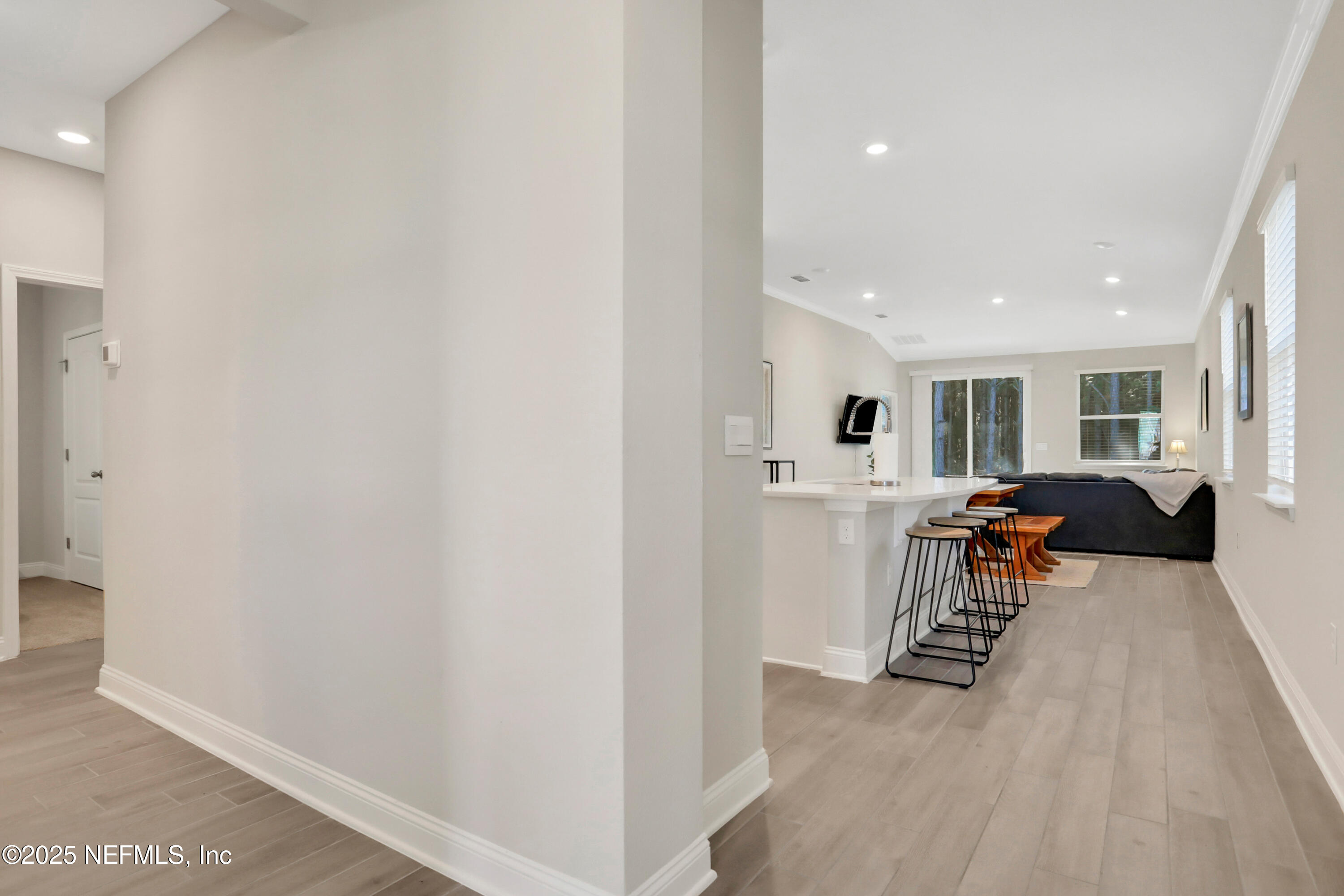404 Thistleton Way Street St. Augustine, FL 32092 - Photo 3 of 36 a living room with furniture and a wooden floor