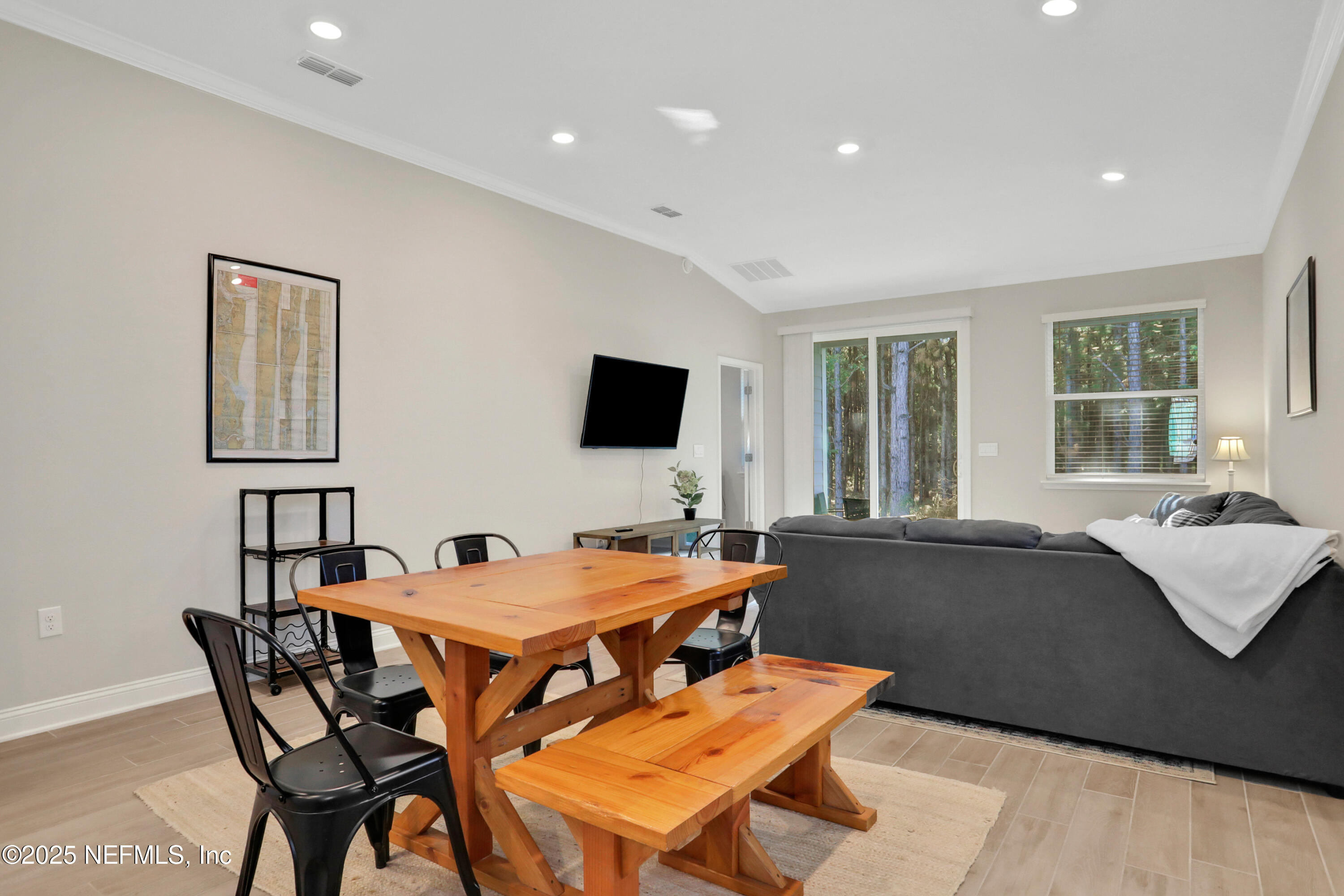 404 Thistleton Way Street St. Augustine, FL 32092 - Photo 8 of 36 a living room with furniture and a flat screen tv