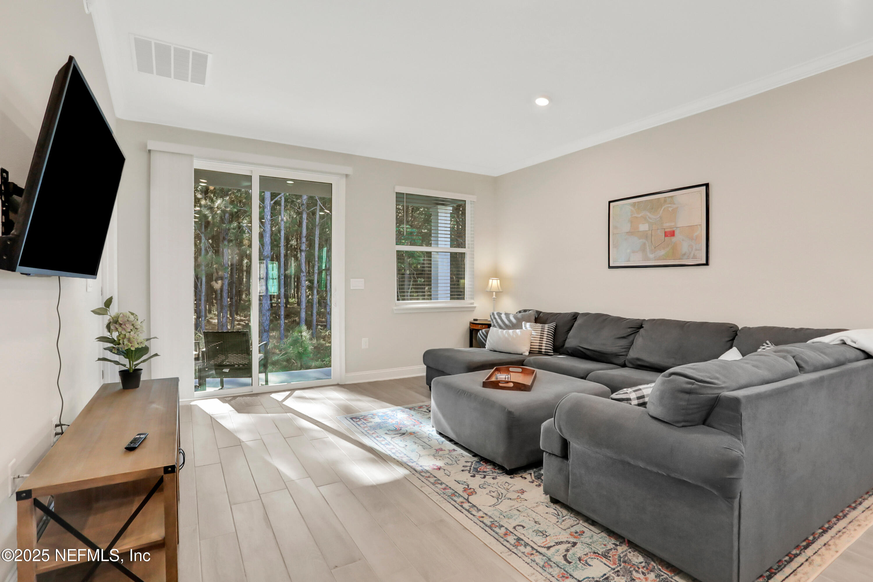 404 Thistleton Way Street St. Augustine, FL 32092 - Photo 10 of 36 a living room with furniture and a flat screen tv