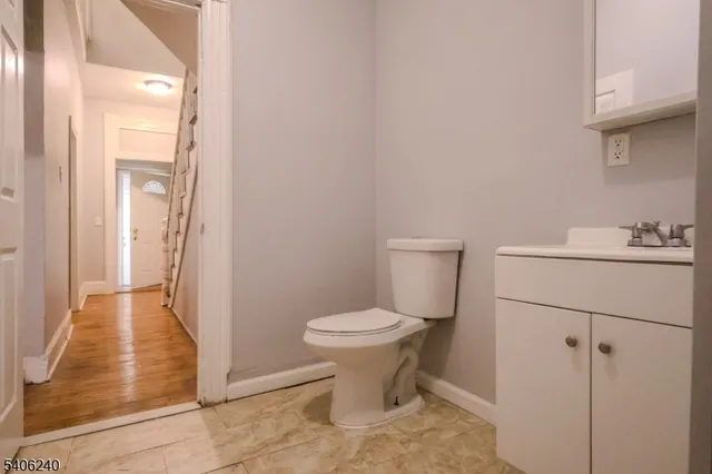 a bathroom with a sink toilet and a mirror