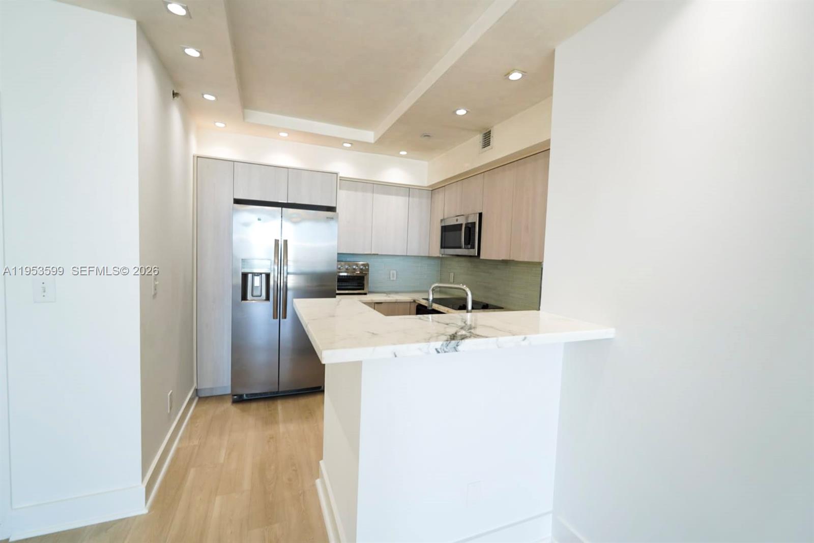 325 South Biscayne Boulevard, Unit 3314 Miami, FL 33131 - Photo 11 of 30 a kitchen with a sink a refrigerator and cabinets