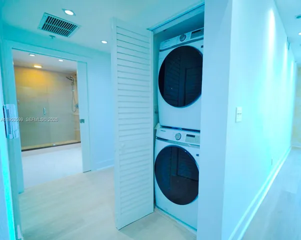 a view of a hallway with washer and dryer