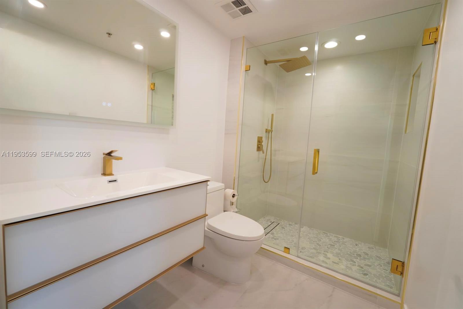 325 South Biscayne Boulevard, Unit 3314 Miami, FL 33131 - Photo 20 of 30 a bathroom with a sink a toilet and shower