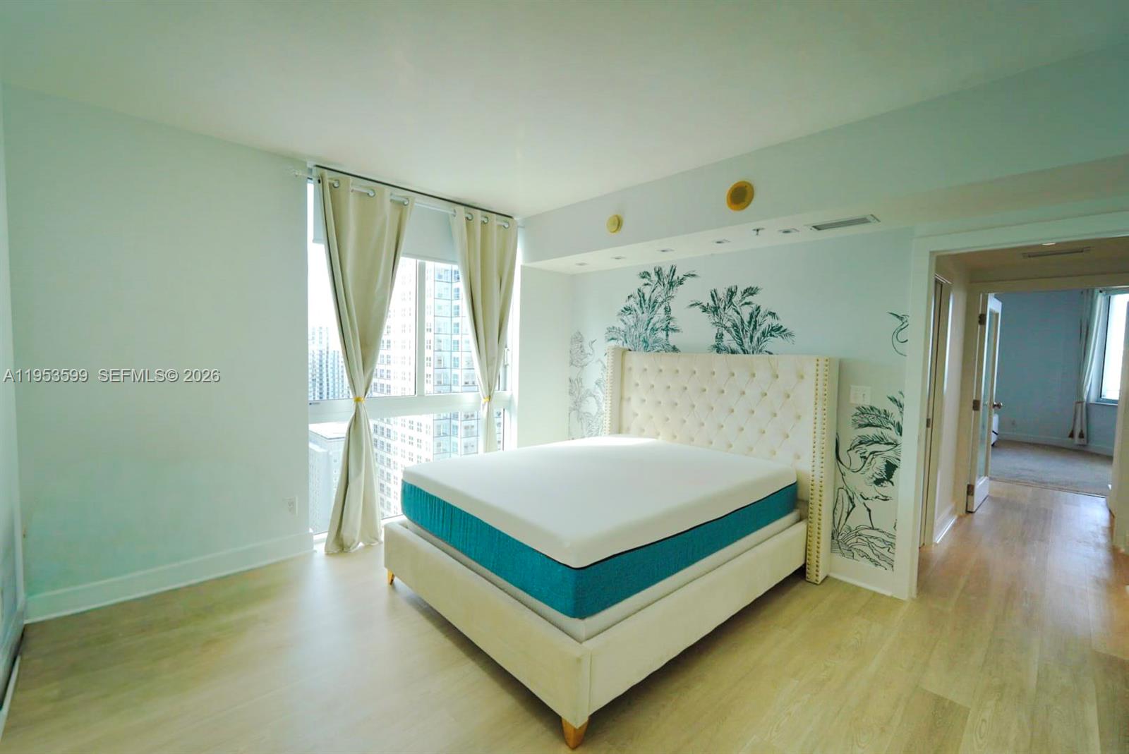 325 South Biscayne Boulevard, Unit 3314 Miami, FL 33131 - Photo 21 of 30 a spacious bedroom with a bed and a window