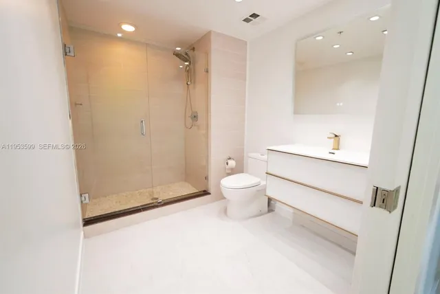 a bathroom with a toilet sink and a shower