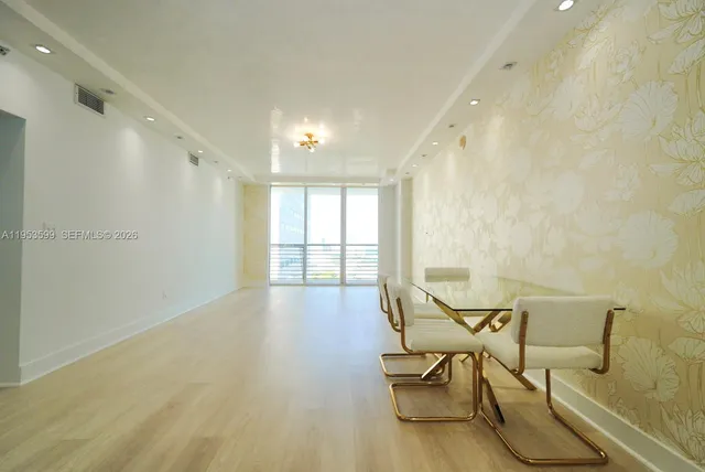 a view of a room with furniture and wooden floor