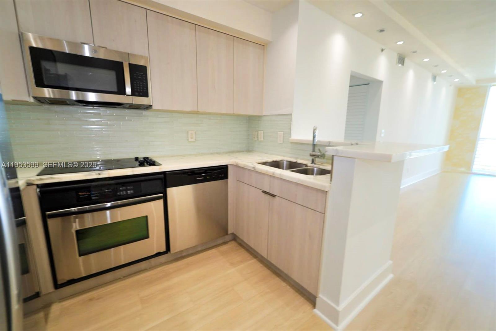 325 South Biscayne Boulevard, Unit 3314 Miami, FL 33131 - Photo 10 of 30 a kitchen with stainless steel appliances granite countertop a sink stove a microwave and cabinets