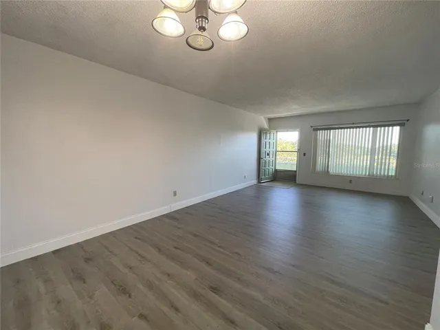 a kitchen with granite countertop a refrigerator and a stove top oven