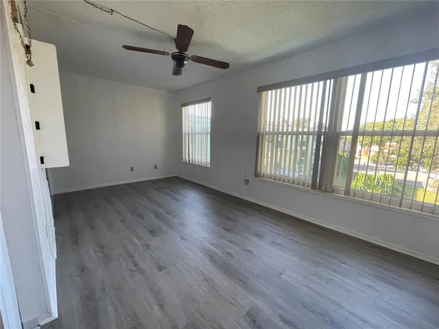 a view of an empty room with a ceiling fan