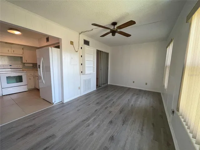 a view of a livingroom with an empty space and a window