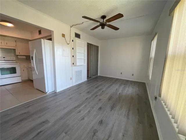 a view of an empty room with glass door