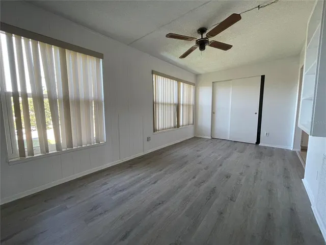 a bathroom with a granite countertop toilet and a sink