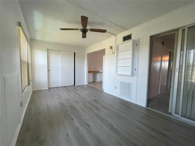 a bathroom with a granite countertop sink a toilet and shower