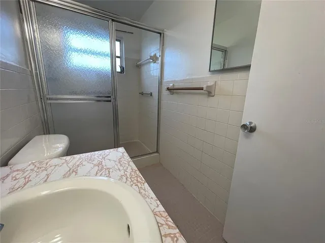 a bathroom with a shower and toilet