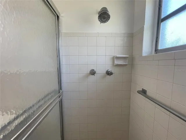 a bathroom with a glass shower door
