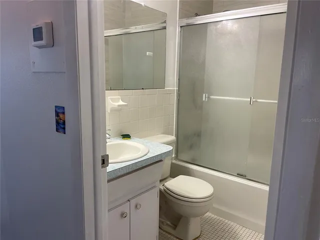 an empty room with windows ceiling fan and windows