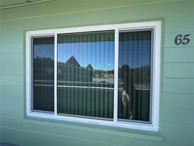 a view of a big room with wooden floor and window