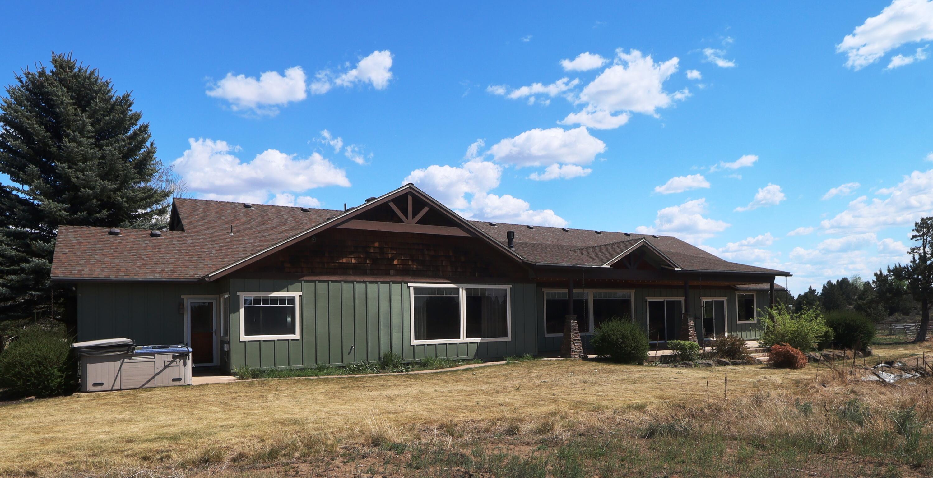 21491 Bear Creek Road Bend, OR 97701 - Photo 5 of 45 a front view of a house with a yard