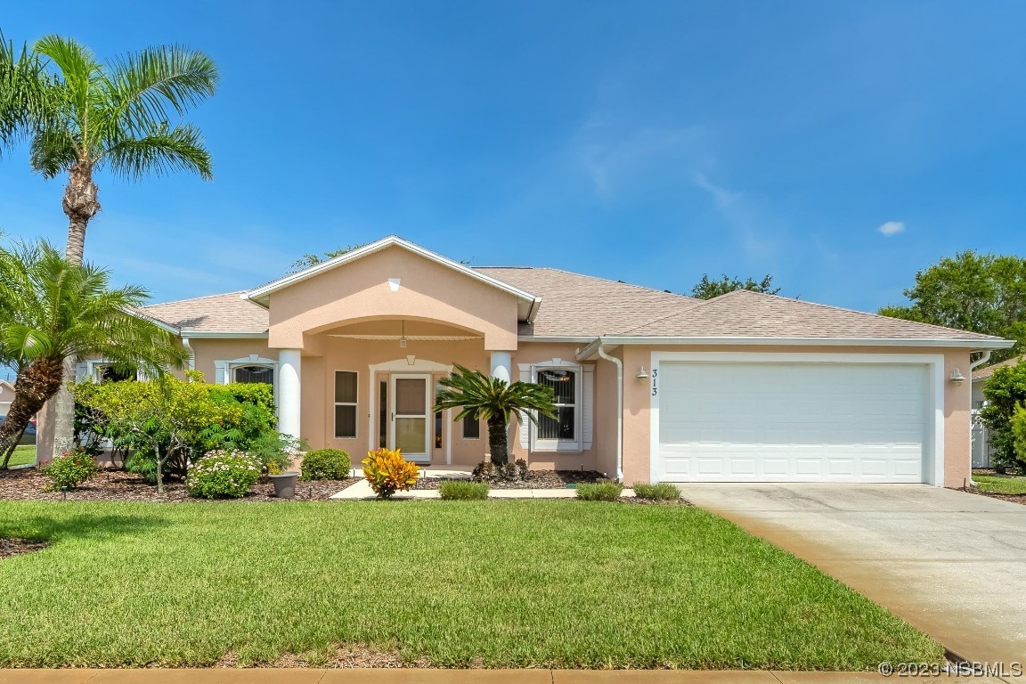 313 Mariners Gate Drive Edgewater, FL 32141 - Photo 1 of 55 a front view of a house with a yard