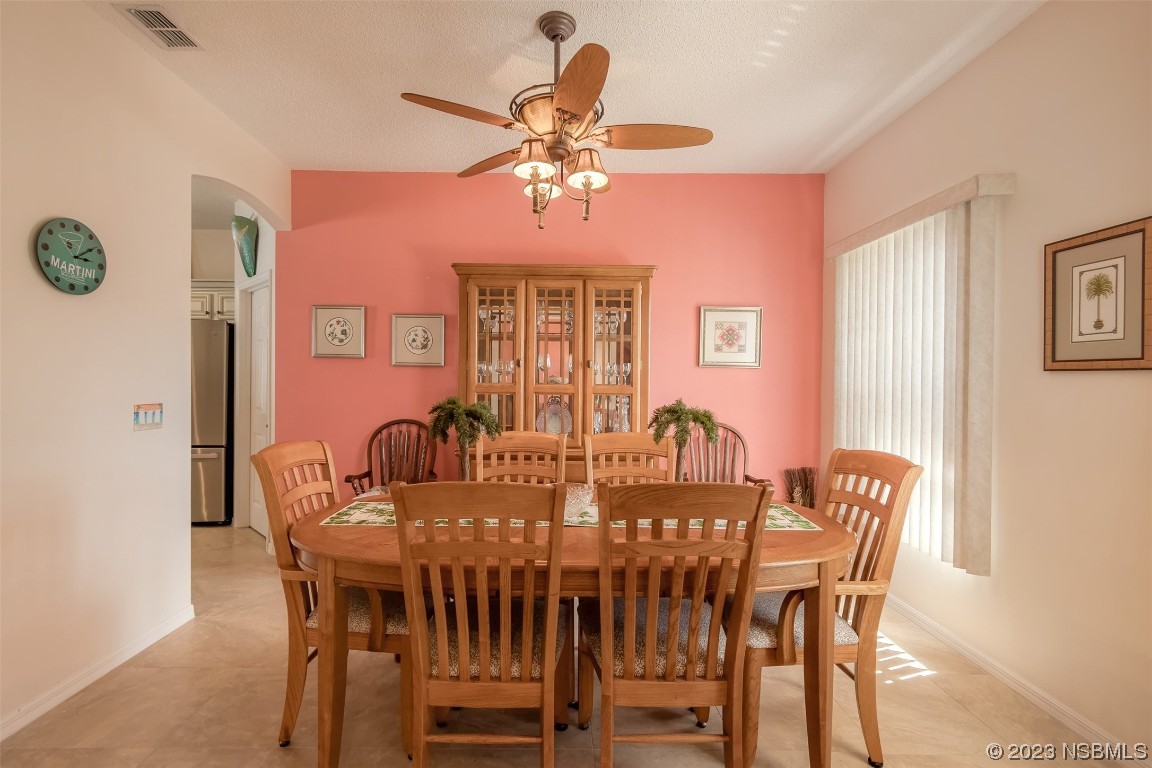 313 Mariners Gate Drive Edgewater, FL 32141 - Photo 16 of 55 a view of a dining room with furniture and chandelier
