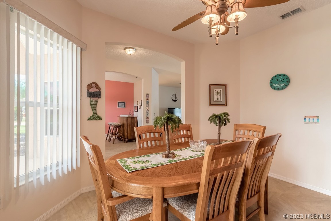 313 Mariners Gate Drive Edgewater, FL 32141 - Photo 18 of 55 a view of a dining room with furniture window and outside view