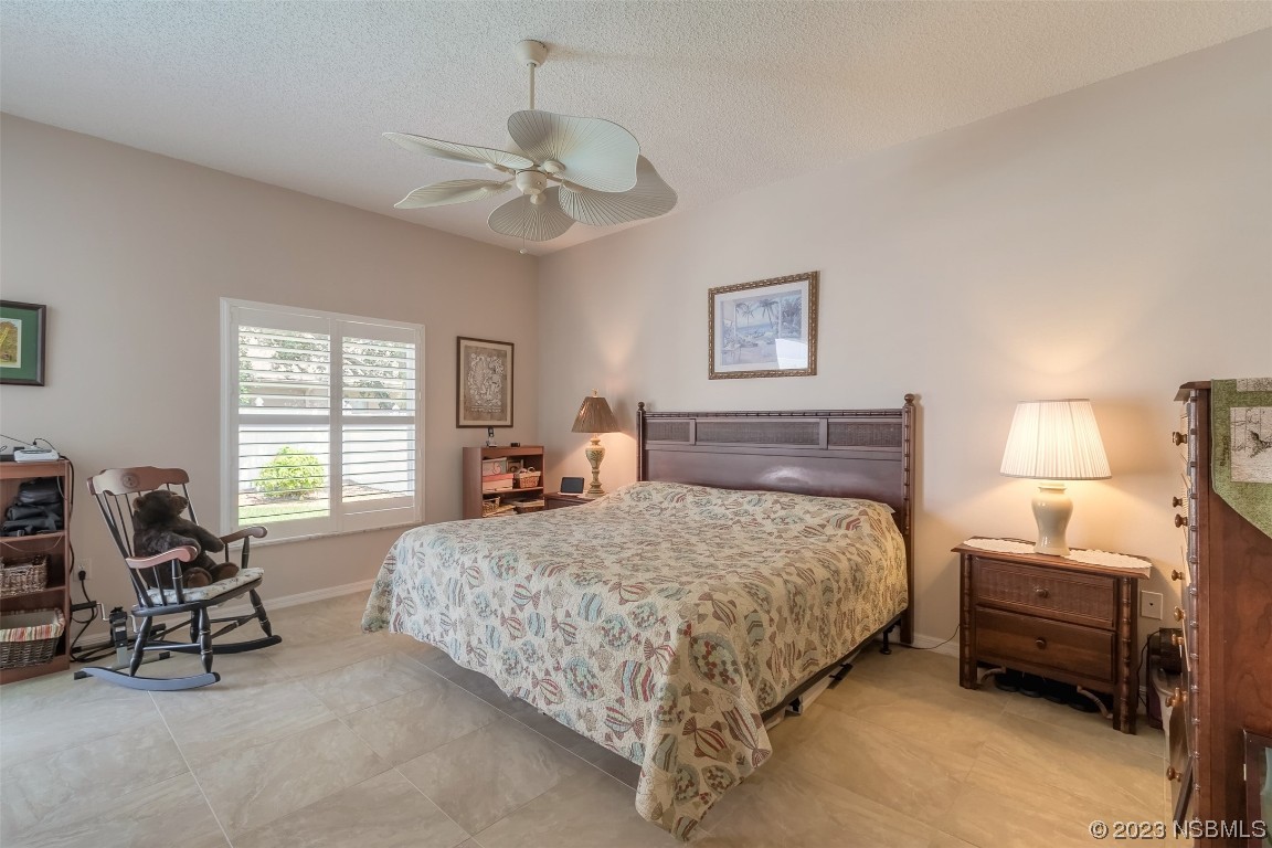 313 Mariners Gate Drive Edgewater, FL 32141 - Photo 19 of 55 a bedroom with a bed and a window