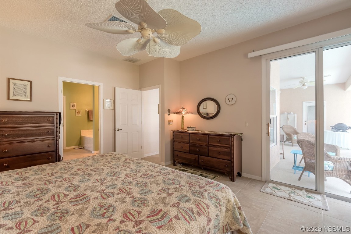 313 Mariners Gate Drive Edgewater, FL 32141 - Photo 20 of 55 a bedroom with a bed and a chandelier