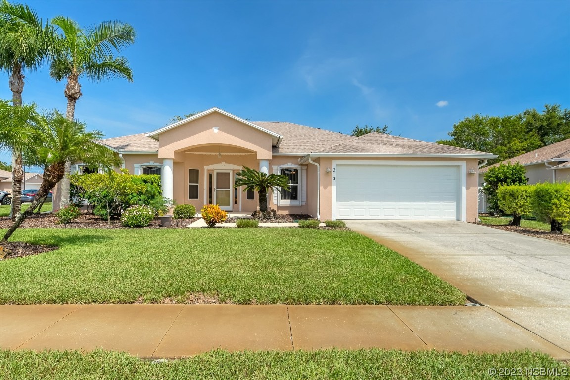313 Mariners Gate Drive Edgewater, FL 32141 - Photo 2 of 55 a front view of a house with a yard and porch