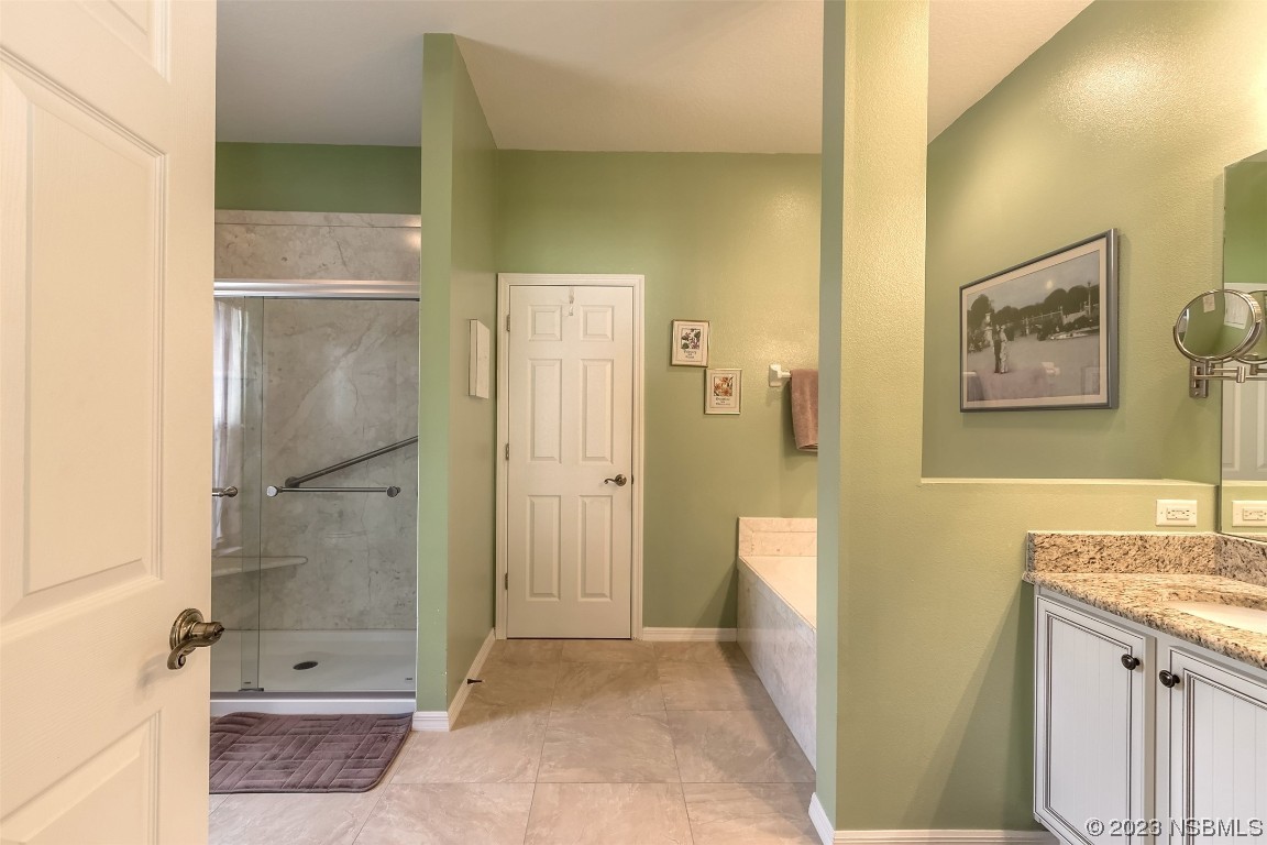 313 Mariners Gate Drive Edgewater, FL 32141 - Photo 21 of 55 a bathroom with a granite countertop shower mirror and a sink