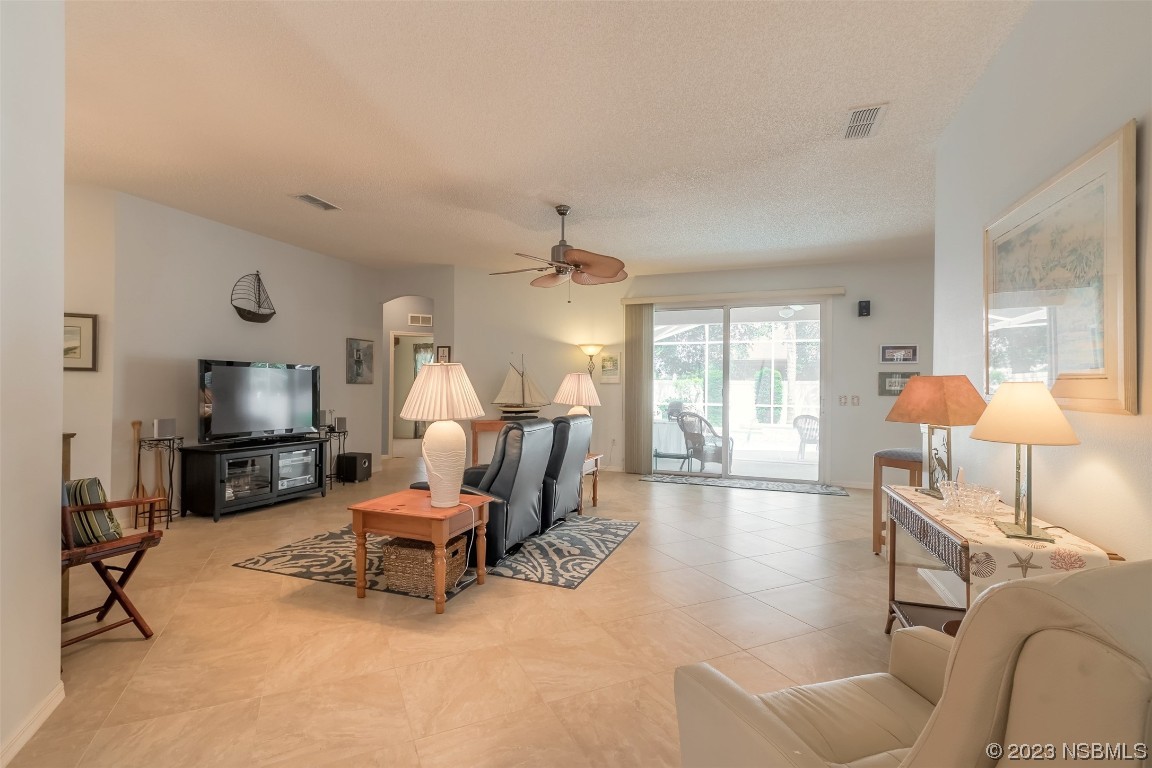313 Mariners Gate Drive Edgewater, FL 32141 - Photo 26 of 55 a living room with furniture and a flat screen tv