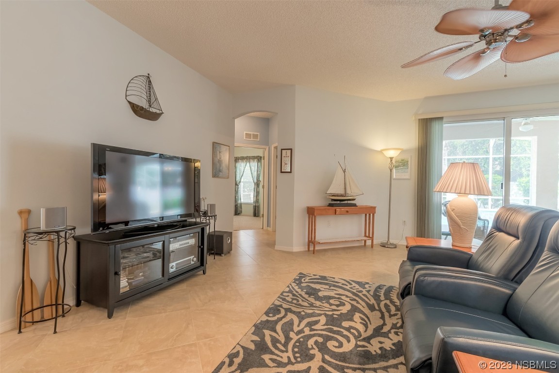 313 Mariners Gate Drive Edgewater, FL 32141 - Photo 27 of 55 a living room with furniture and a flat screen tv
