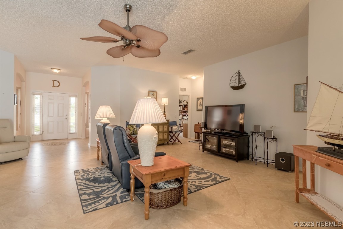 313 Mariners Gate Drive Edgewater, FL 32141 - Photo 30 of 55 a living room with furniture a flat screen tv and kitchen view