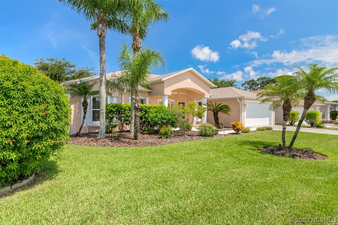 313 Mariners Gate Drive Edgewater, FL 32141 - Photo 3 of 55 a front view of a house with garden