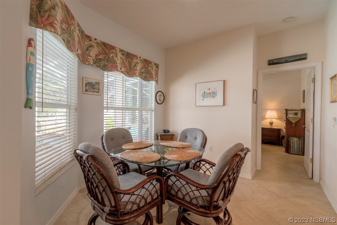 313 Mariners Gate Drive Edgewater, FL 32141 - Photo 32 of 55 a dining room with furniture and window
