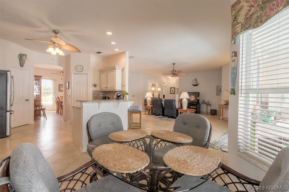313 Mariners Gate Drive Edgewater, FL 32141 - Photo 33 of 55 a living room with furniture and a chandelier