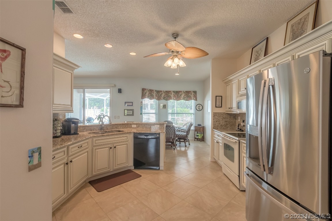 313 Mariners Gate Drive Edgewater, FL 32141 - Photo 36 of 55 a kitchen with stainless steel appliances granite countertop a refrigerator and a sink