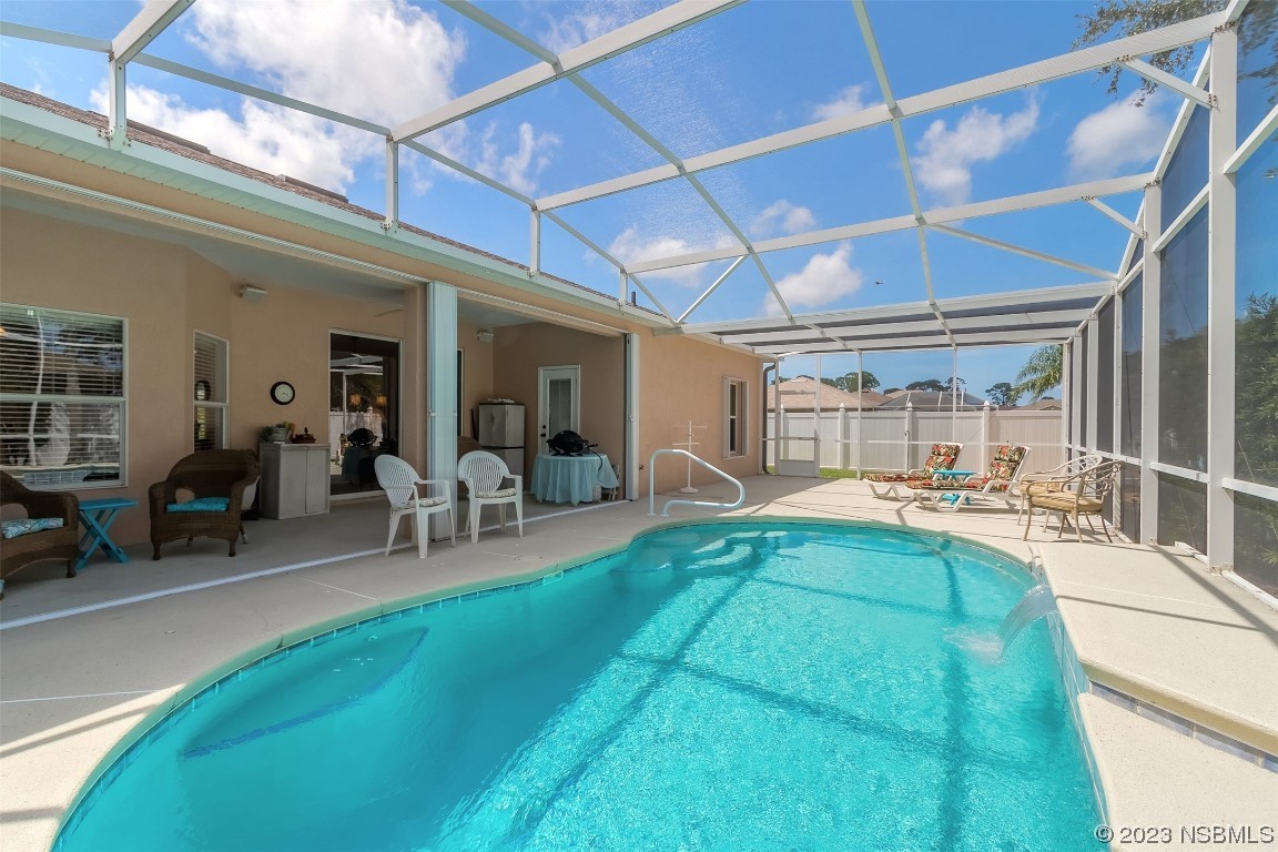 313 Mariners Gate Drive Edgewater, FL 32141 - Photo 41 of 55 a view of a backyard with table and chairs and a barbeque